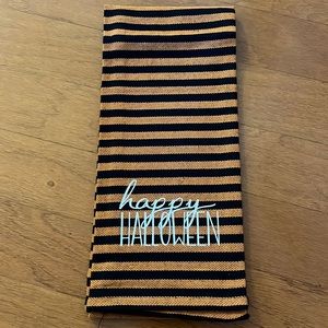 Black and orange stripe dish towel with “Happy Halloween” in white